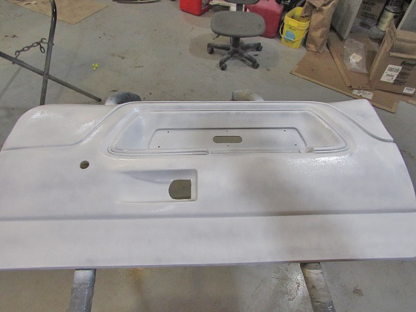 The panel was sprayed with a white guide coat before sanding. This helps us see all the damaged areas. 