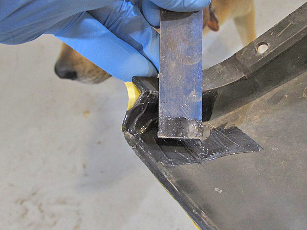 Next, the epoxy gets pressed into the split from the back side. This reduces the amount of finish work required on the visible side. 